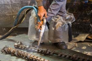 Worker is cleaning the machine equipment